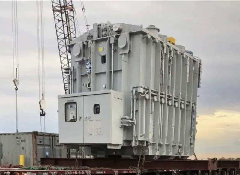 A large substation power transformer loaded on a rail flatcar