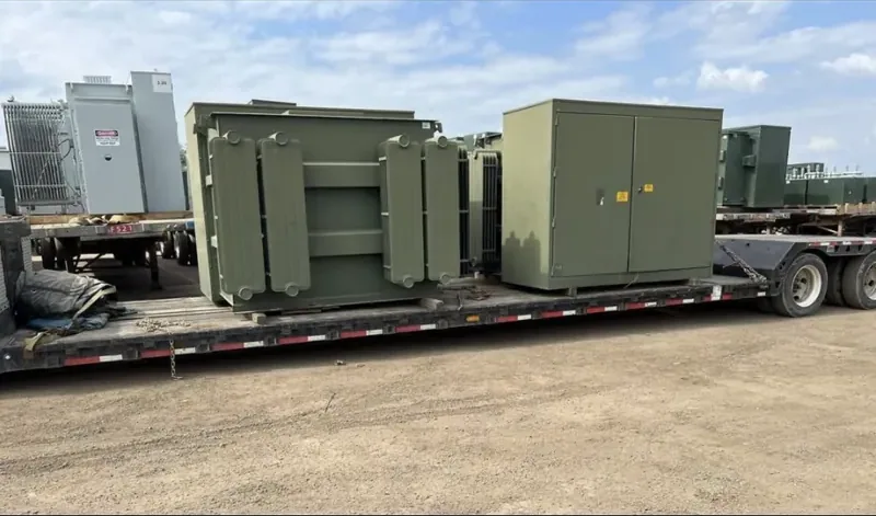 Padmount transformers loaded and strapped on a lowboy trailer