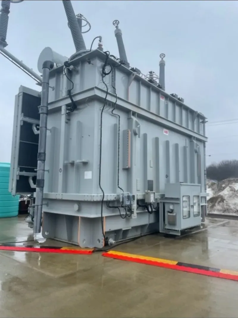A large grey oil-filled substation transformer indoors