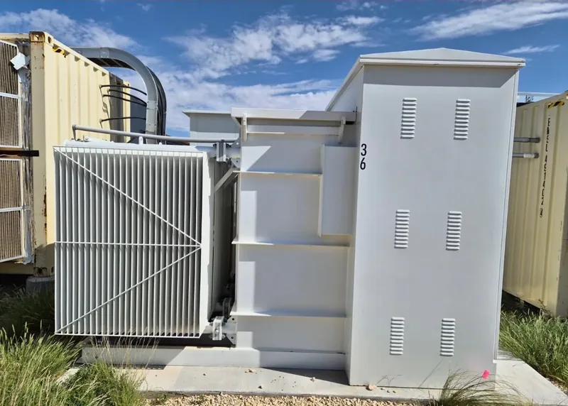 An oil-filled transformer with its radiator bank alongside