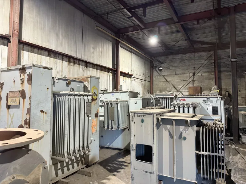 Used transformers inside a warehouse with bushings visible